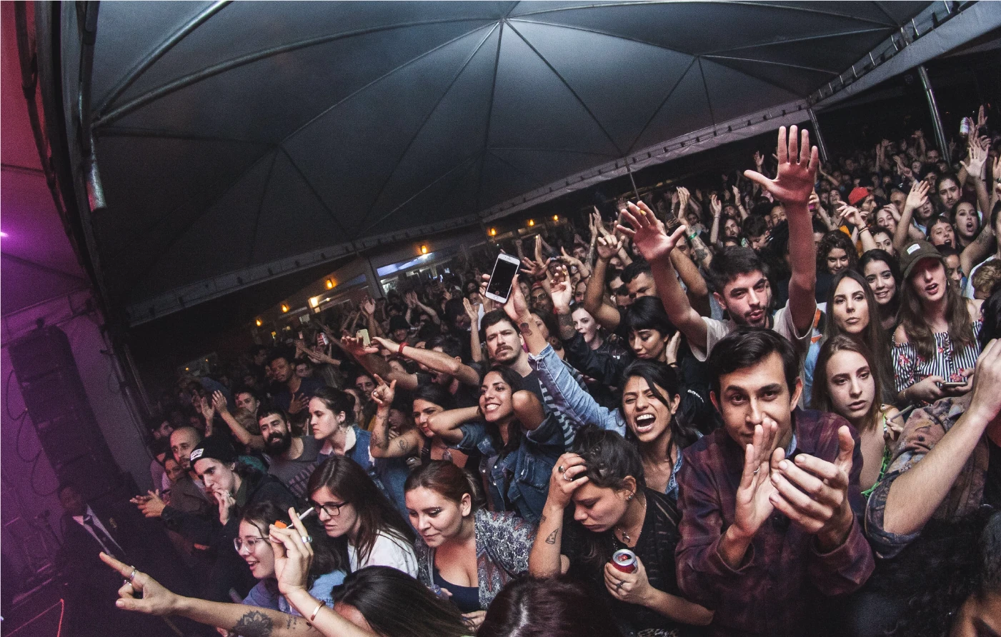 A packed crowd with hands raised at a Semana Balaclava concert, shot on a fisheye lens.